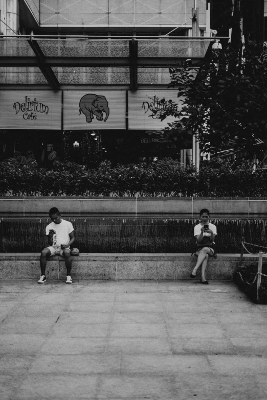 black and white po of two men sitting on benches