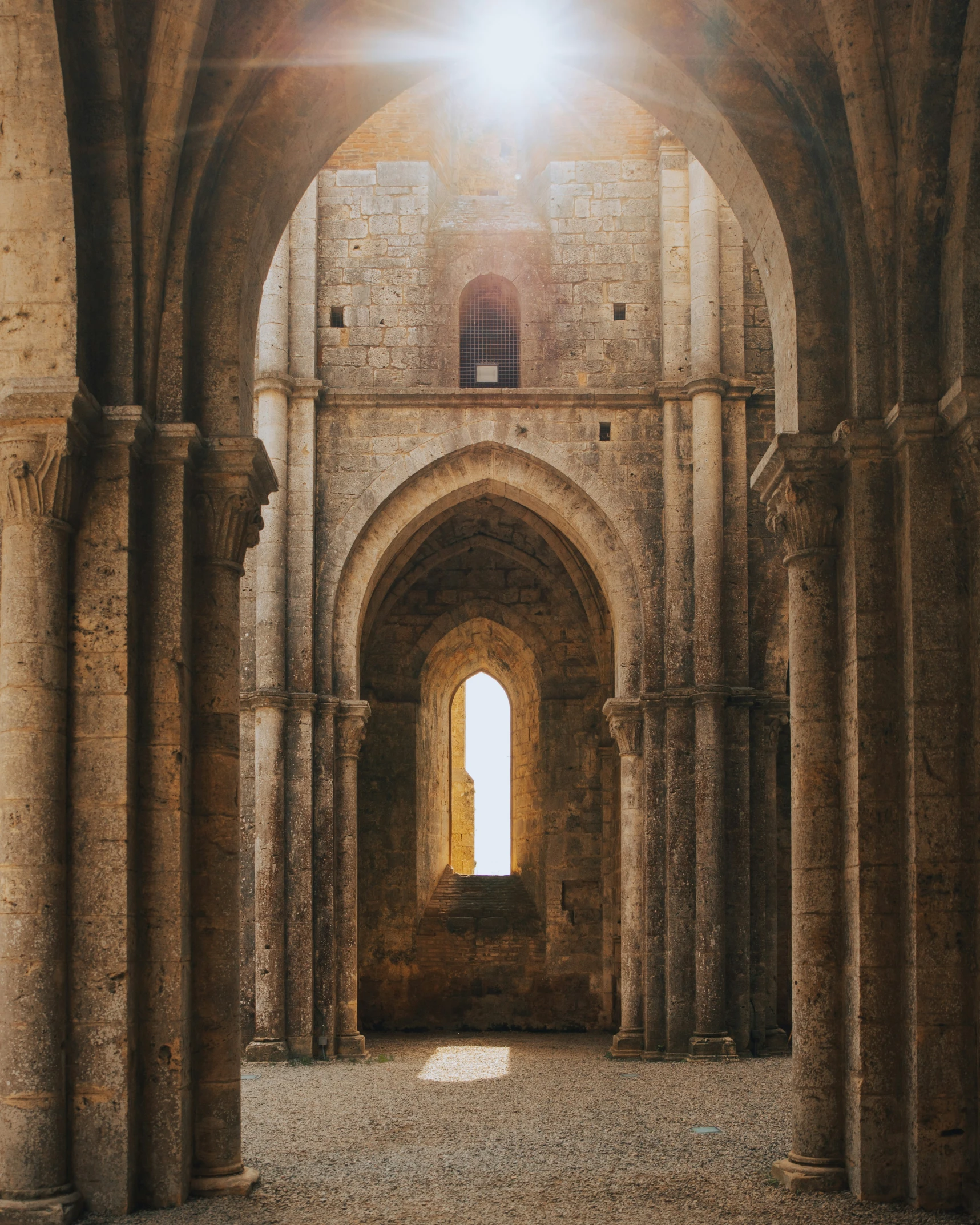 an old stone building has tall arched arches