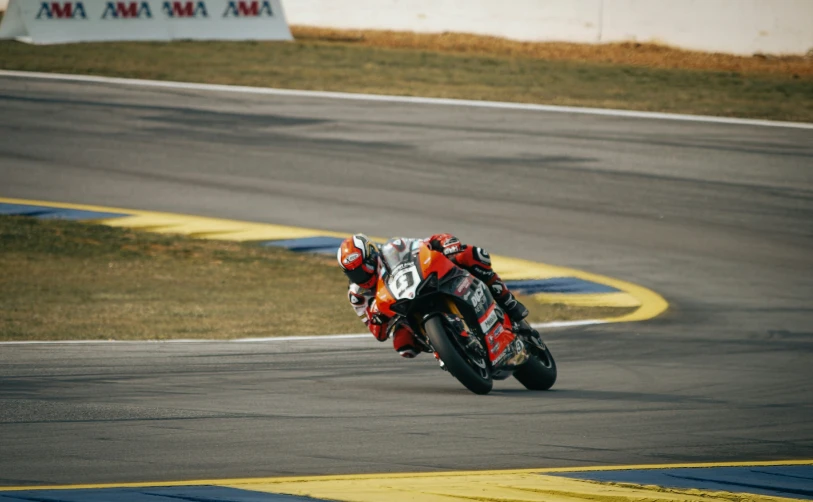 a motorcycle racer races a red and black motorcycle