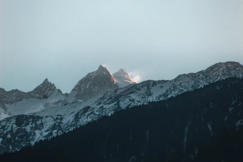 a view of a snowy mountain from behind the snow