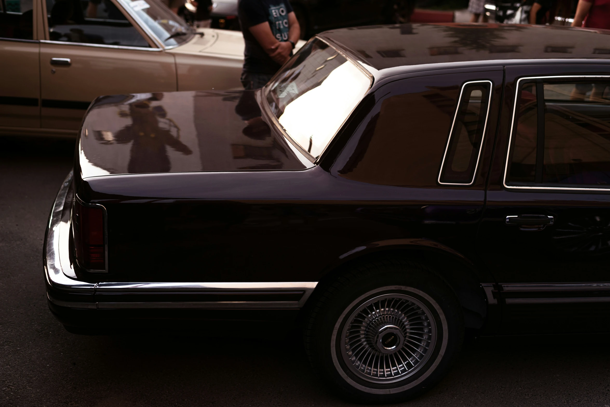 an old black car parked by another car