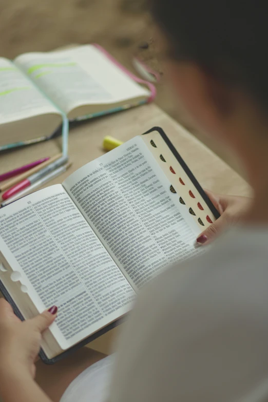 someone reading a bible while at a desk