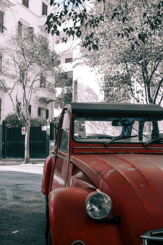 a vintage red truck parked on the side of a road