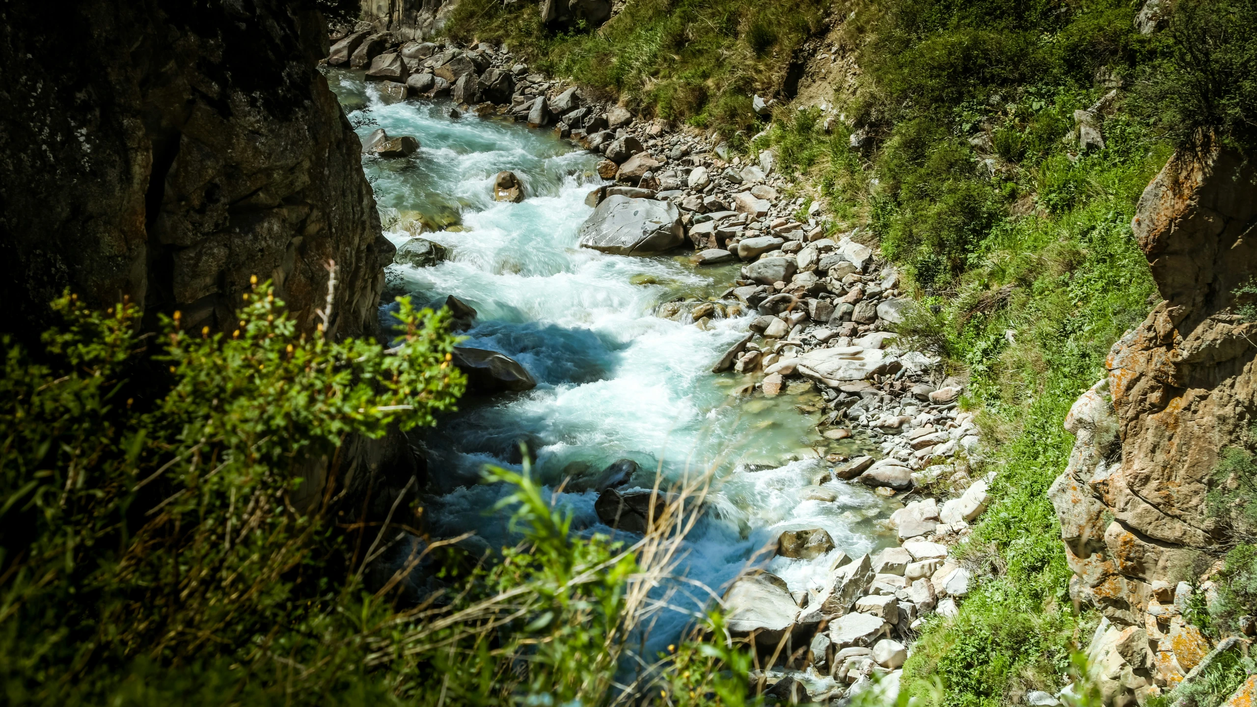 an image of a small river flowing between two rocky cliffs