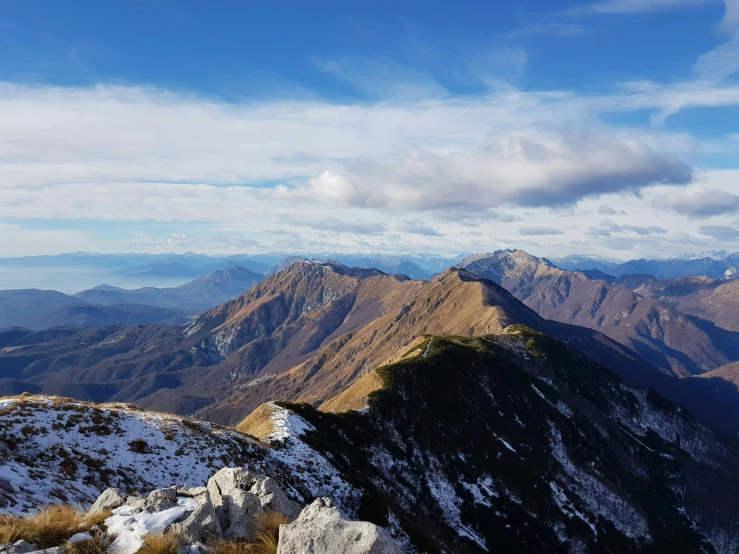 snow on the top of some mountains that are in the distance