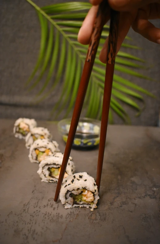 there are two chopsticks sticking out of sushi