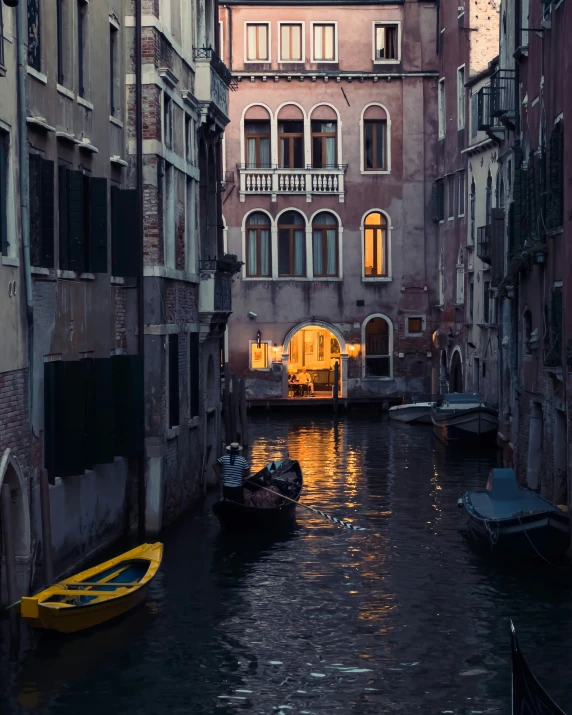 a street with many different buildings on it and water in front of it