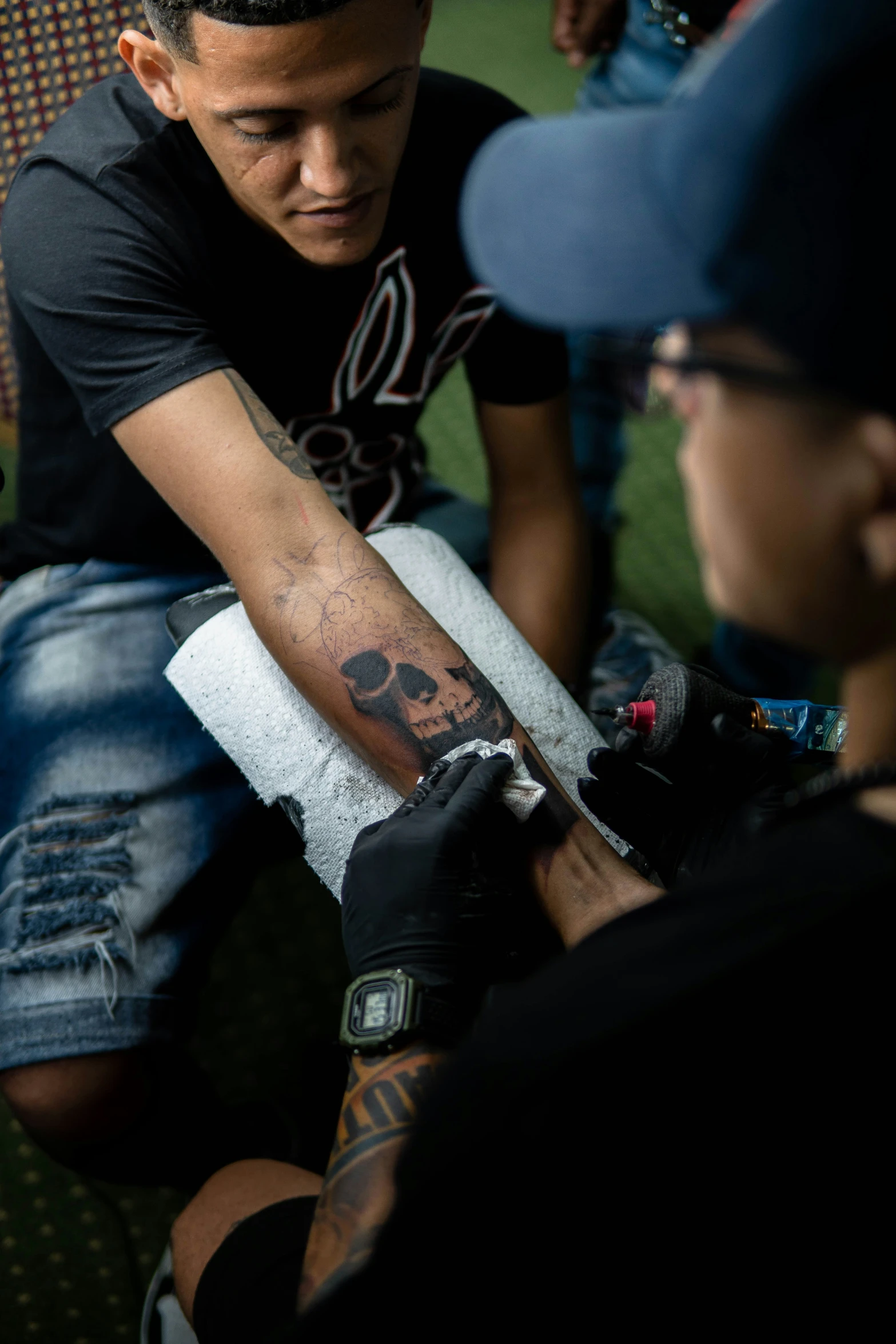 a man getting a tattoo on another man