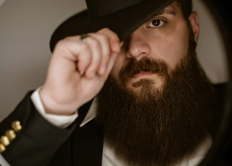 a man with a full beard wearing a jacket