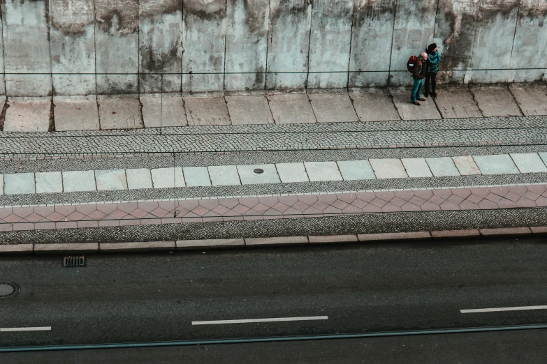 a man sitting on a bench next to a street