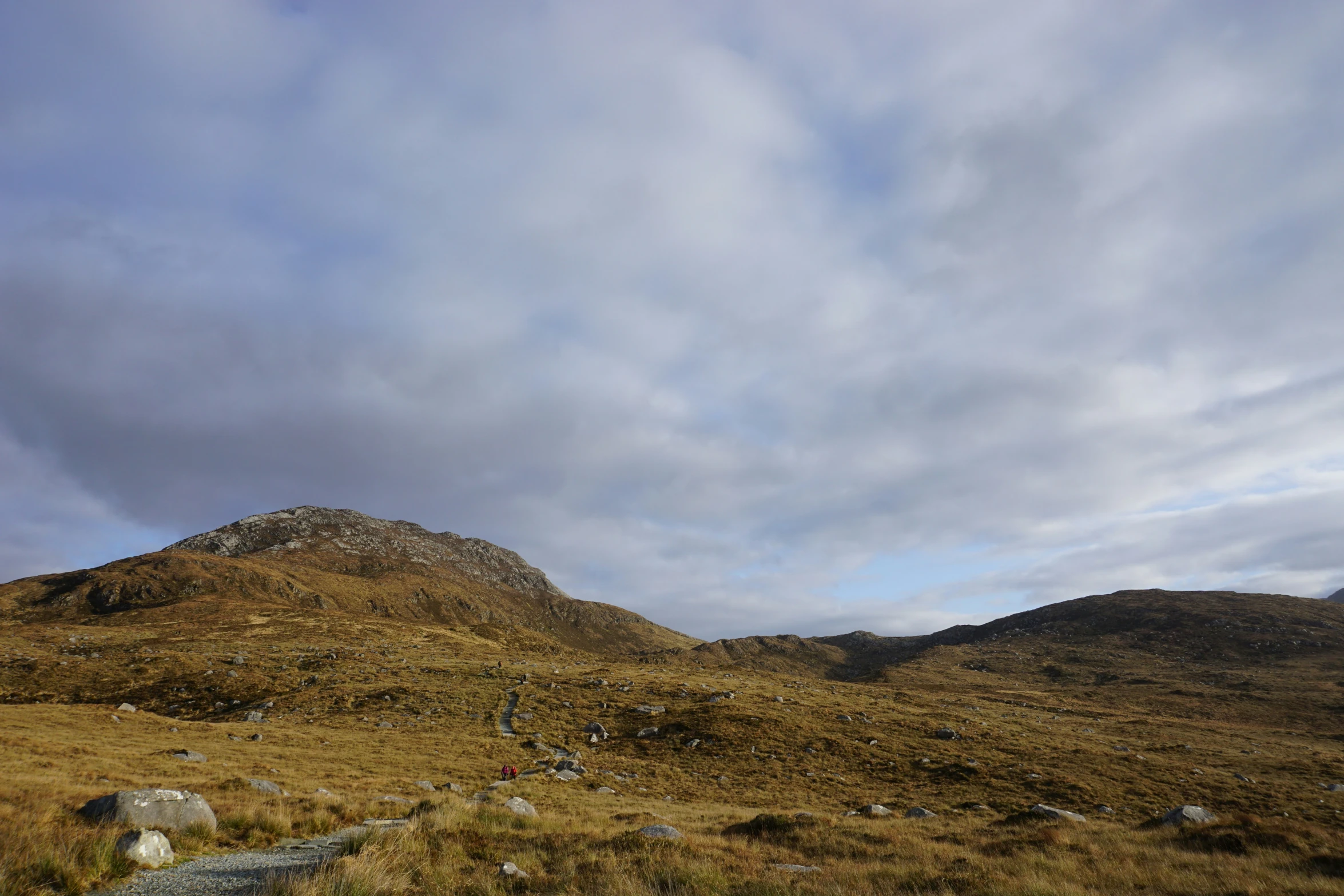 large rocks are sitting on a grassy slope