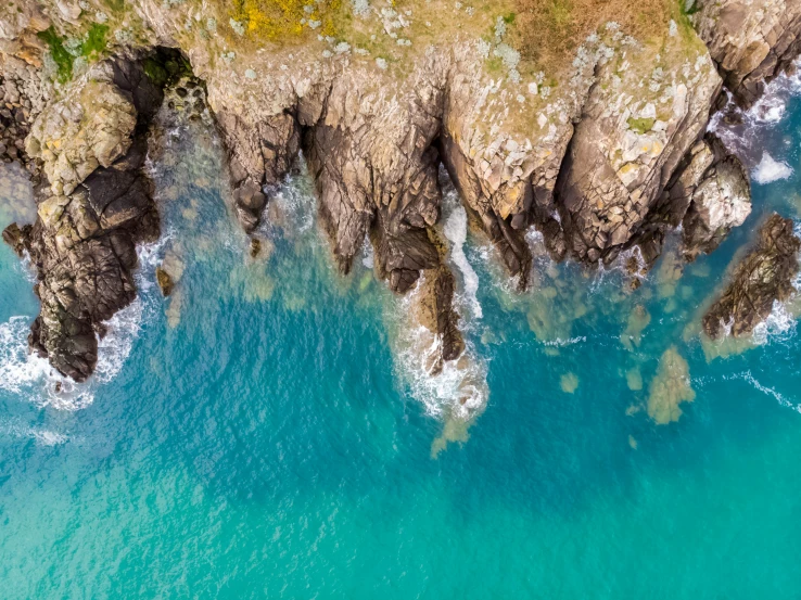 an aerial po looking down at some water near some rocks