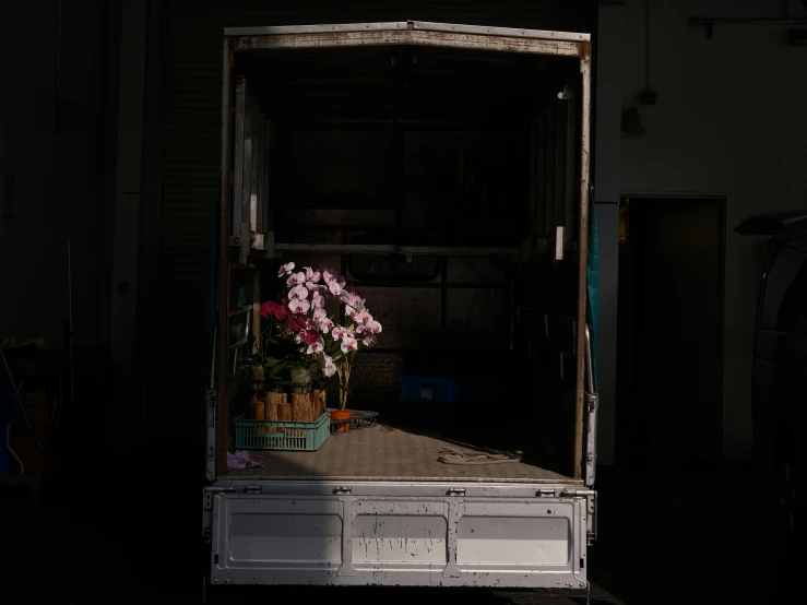 a white trailer with some pink flowers in the back