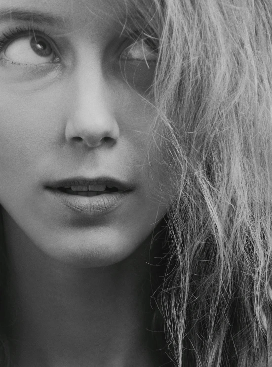 a close up of a woman's face with very long hair