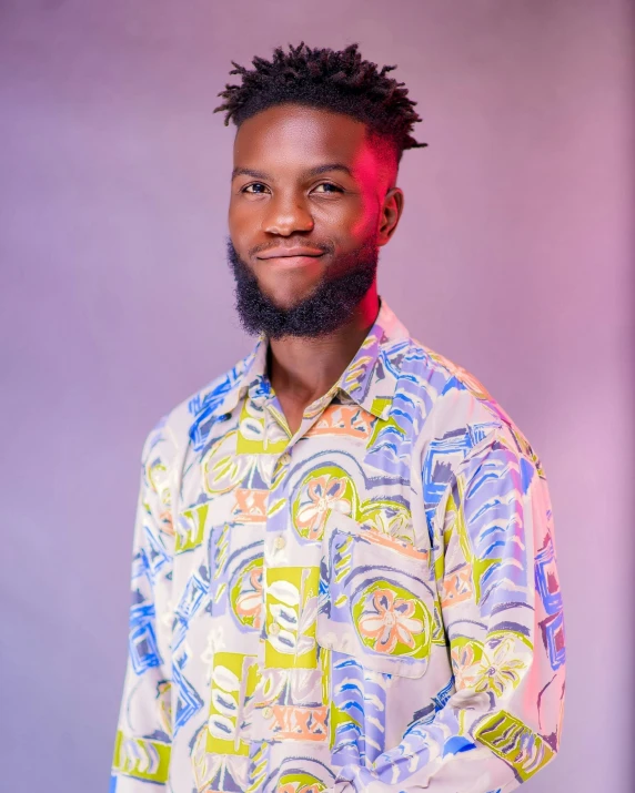 a man with a beard wearing colorful shirts