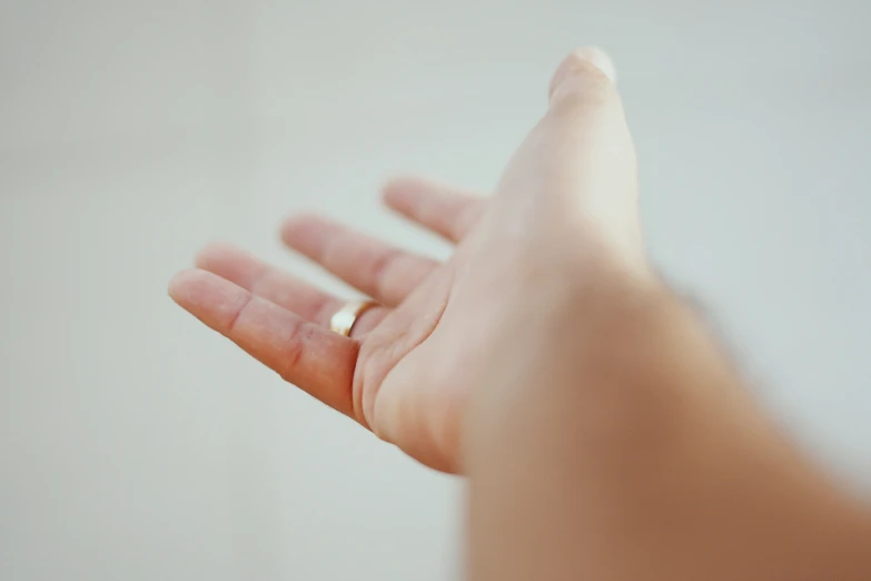 a person holds out their hand in a blurry po