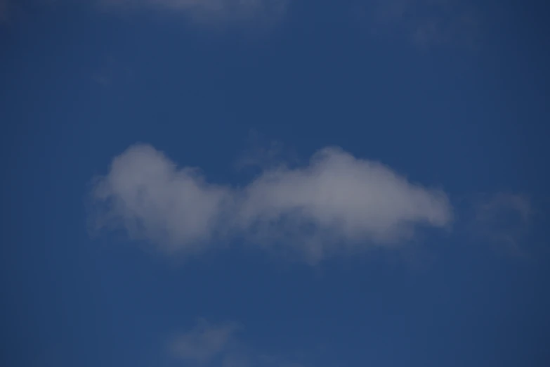 an airplane flying through the cloudy sky