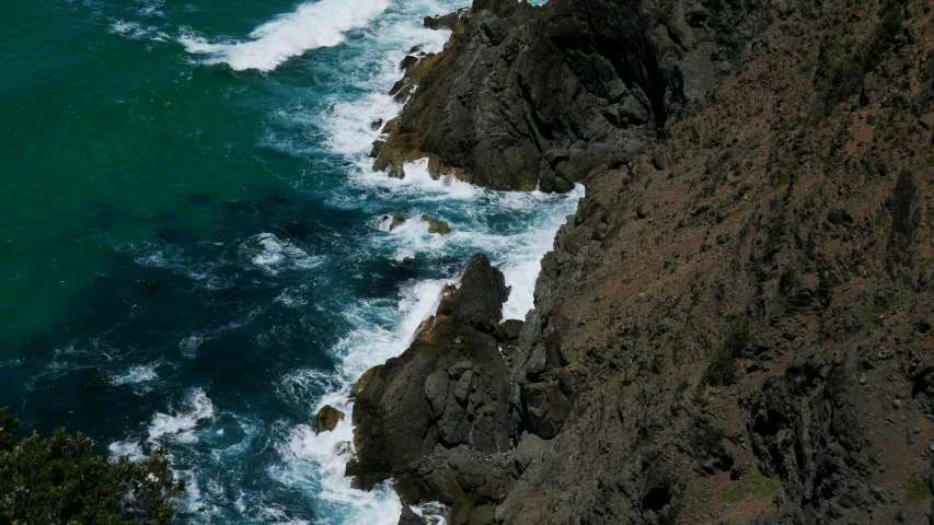 a body of water near some rocks near the shore