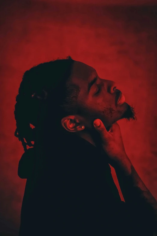 a black man with dreadlocks and red light