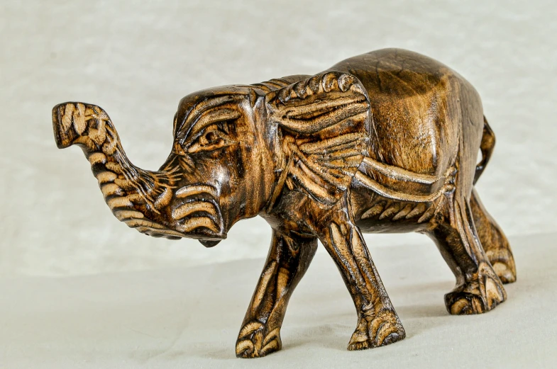 an elephant statue is painted gold, silver and black