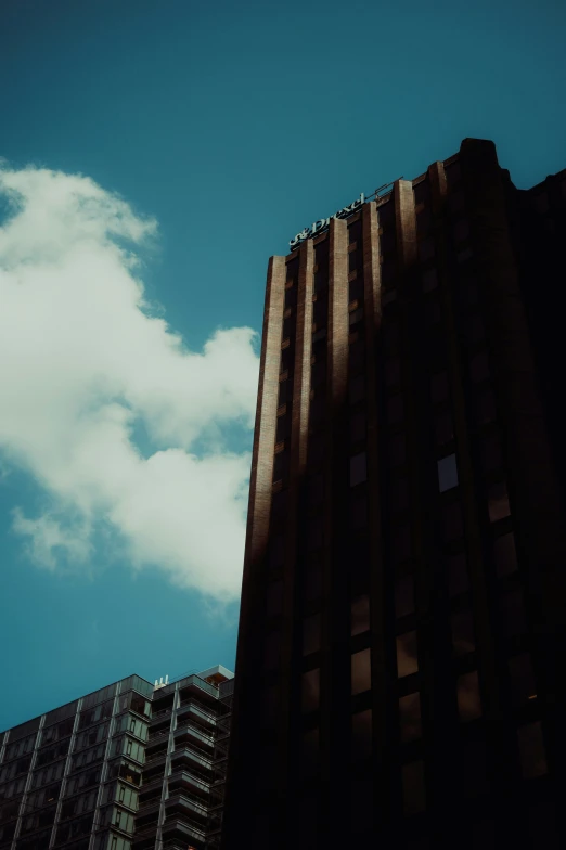 two buildings one is on and the other is up in the sky