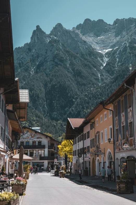 several buildings and mountains in the distance