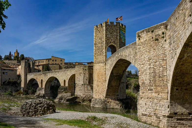 the old buildings are set at the bottom of a very tall tower