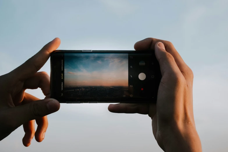 someone holding up their smartphone to take pictures