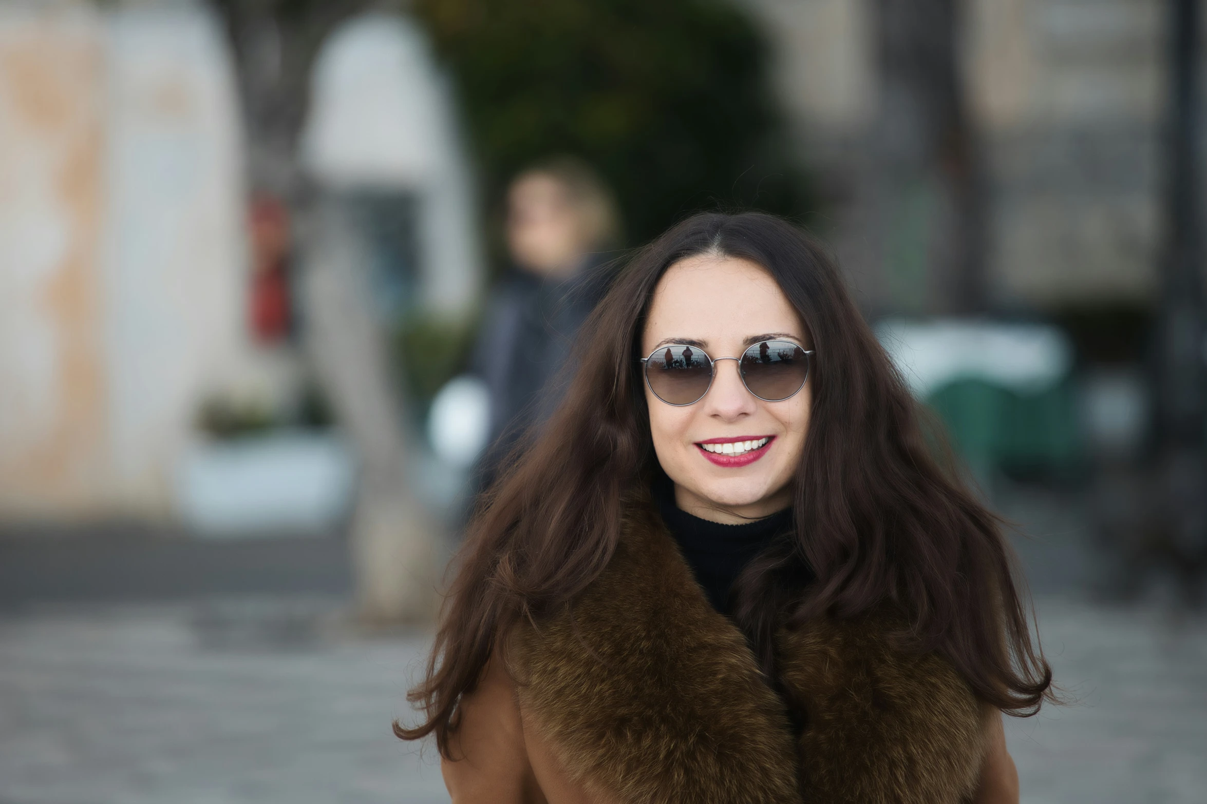 the woman has long hair wearing sunglasses on her head