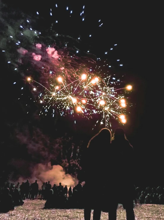 there is a large fireworks show with lots of people watching