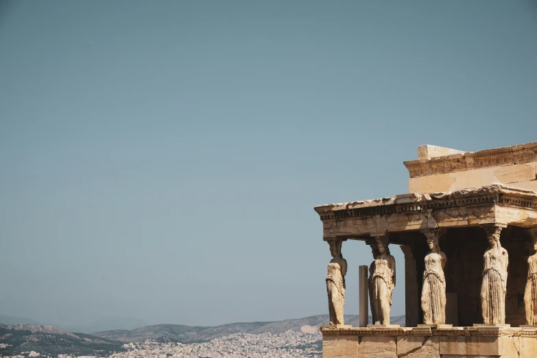 an old building with three sculptures in the foreground