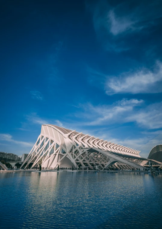 a building is next to the water in front of a blue sky