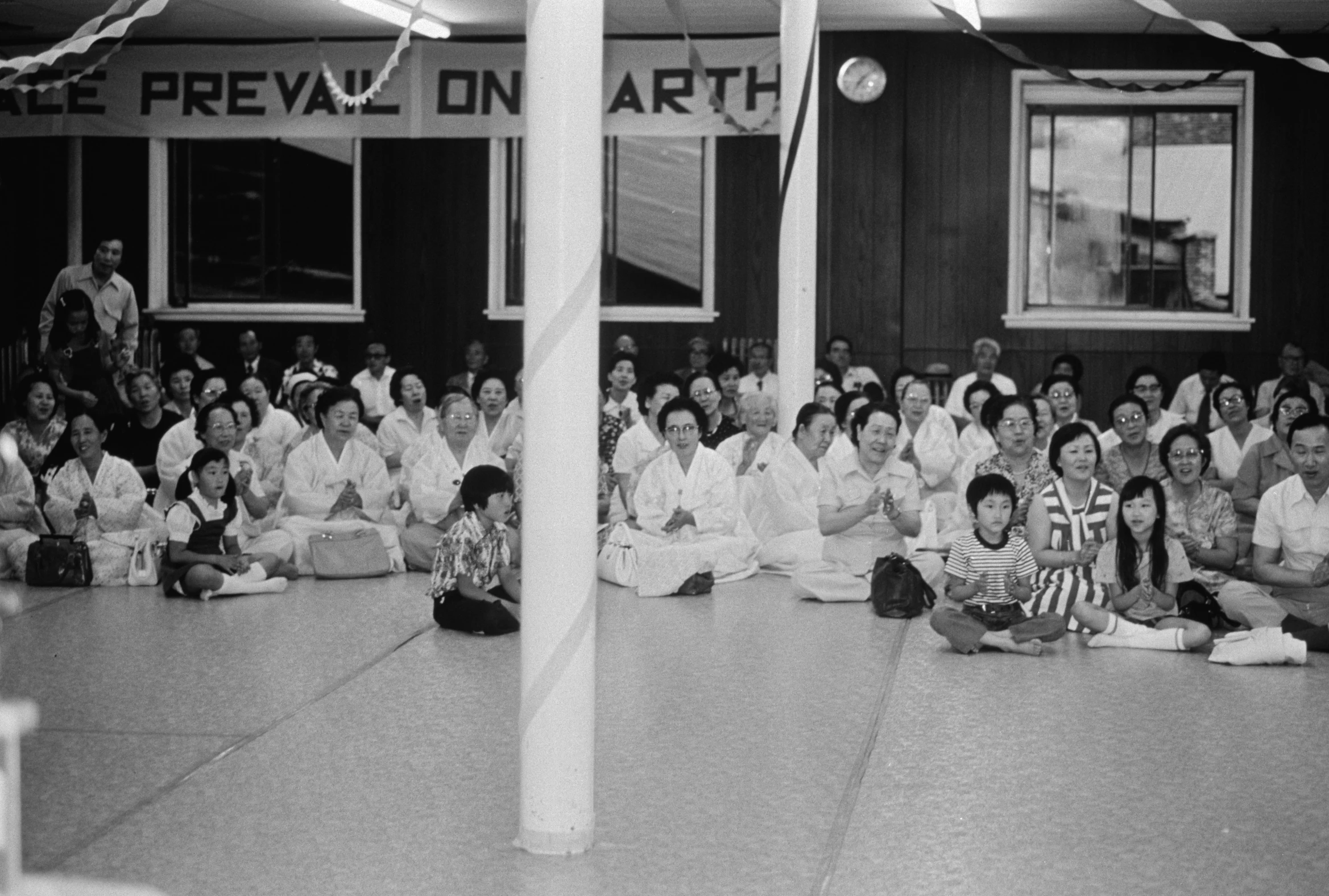 a black and white pograph of people in kimono suits