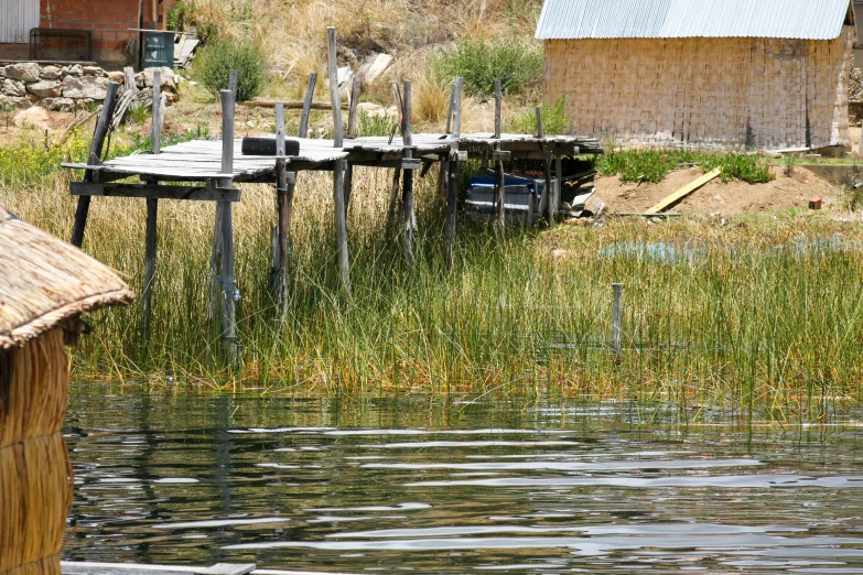 several boats sitting on the shore with tables set out to sit