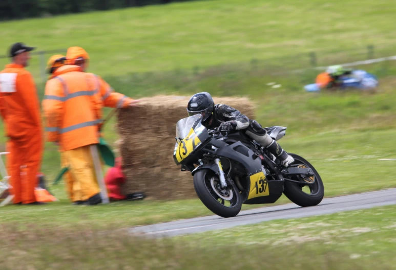 a man on a motorcycle racing around a track