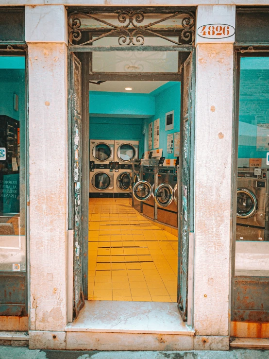 the inside of a washroom with washing machines in the window