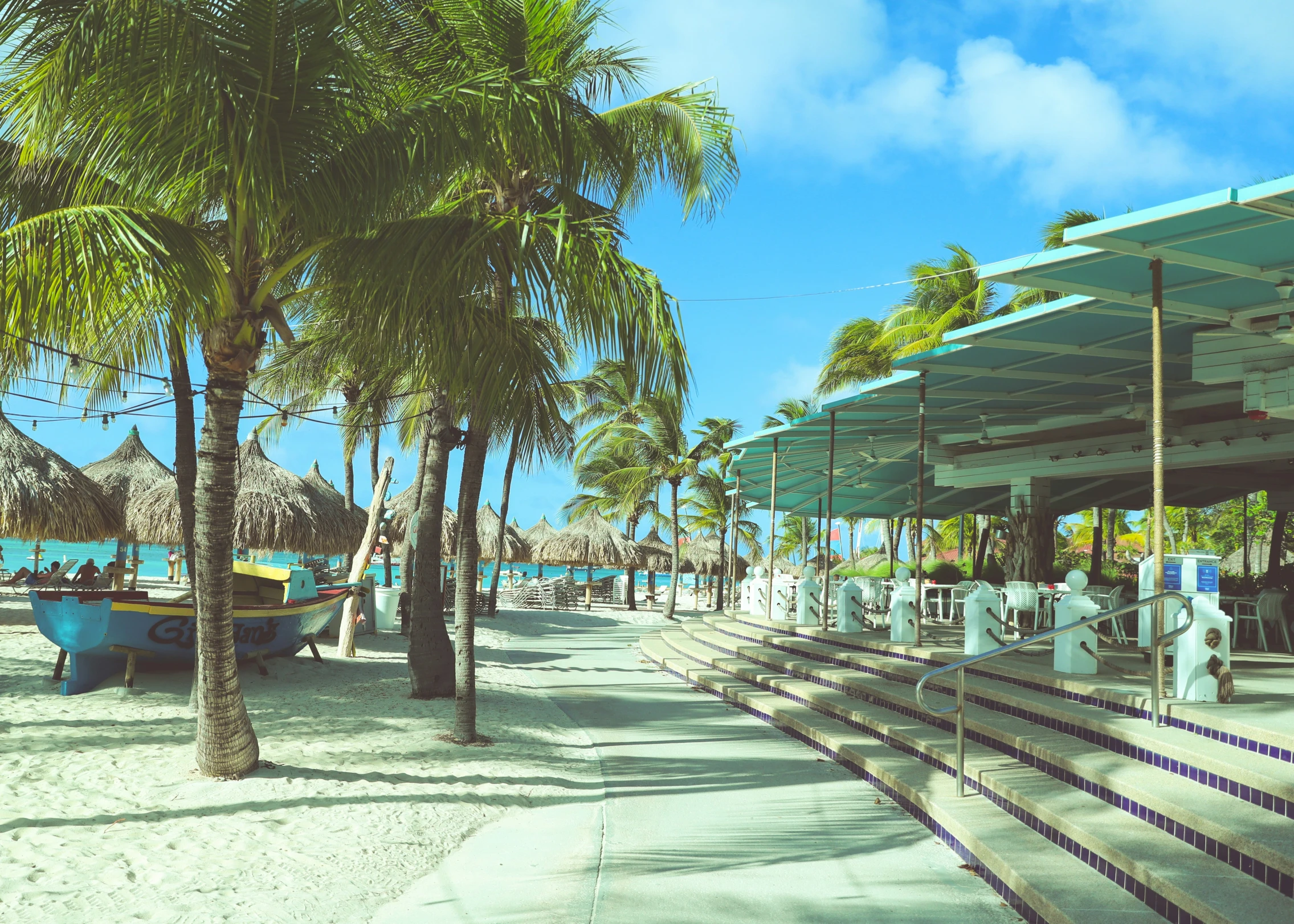 a white sandy beach covered in trees and bushes