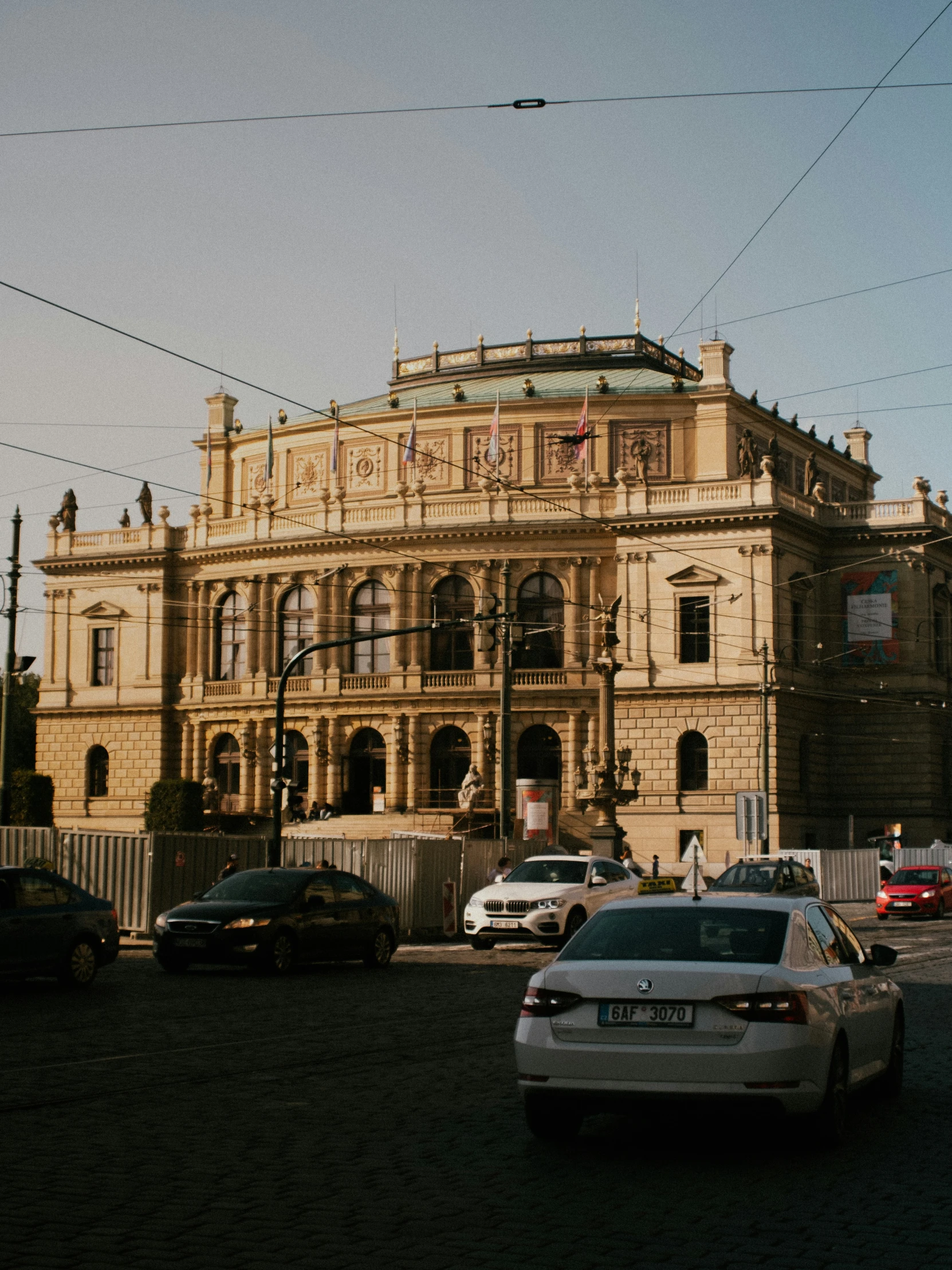 an old building on a street corner in front of some parked cars