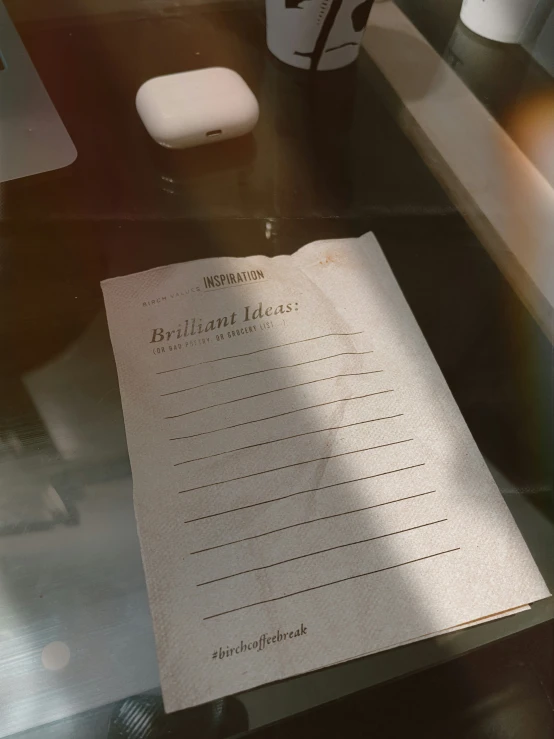 a piece of paper on top of a glass desk