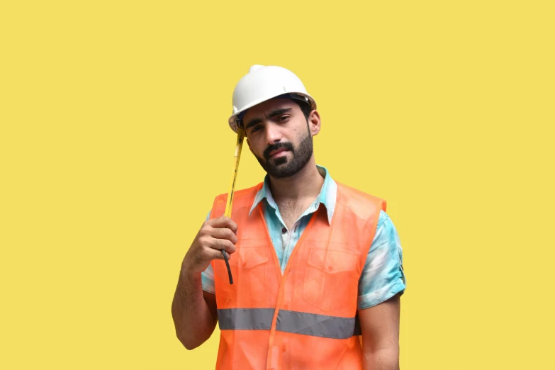a man in safety clothing holding up a toothbrush