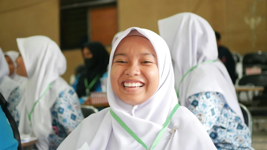 a smiling woman in a white outfit