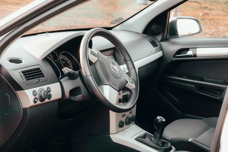 the inside of a car, with a dashboard and steering wheel