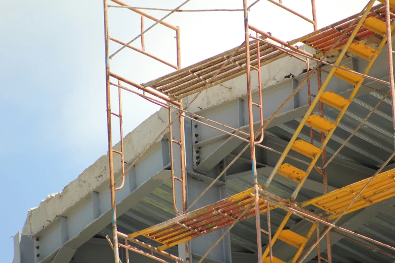 a yellow stair case on the side of a building