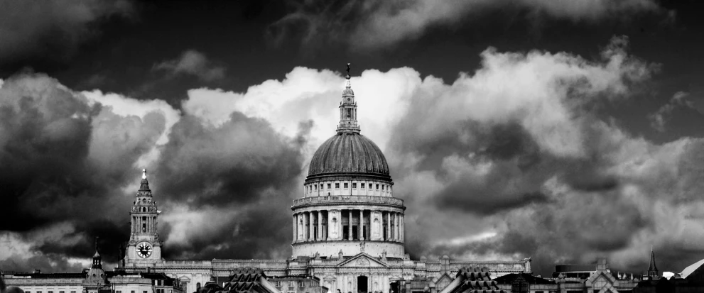 a building with tall spires surrounded by clouds