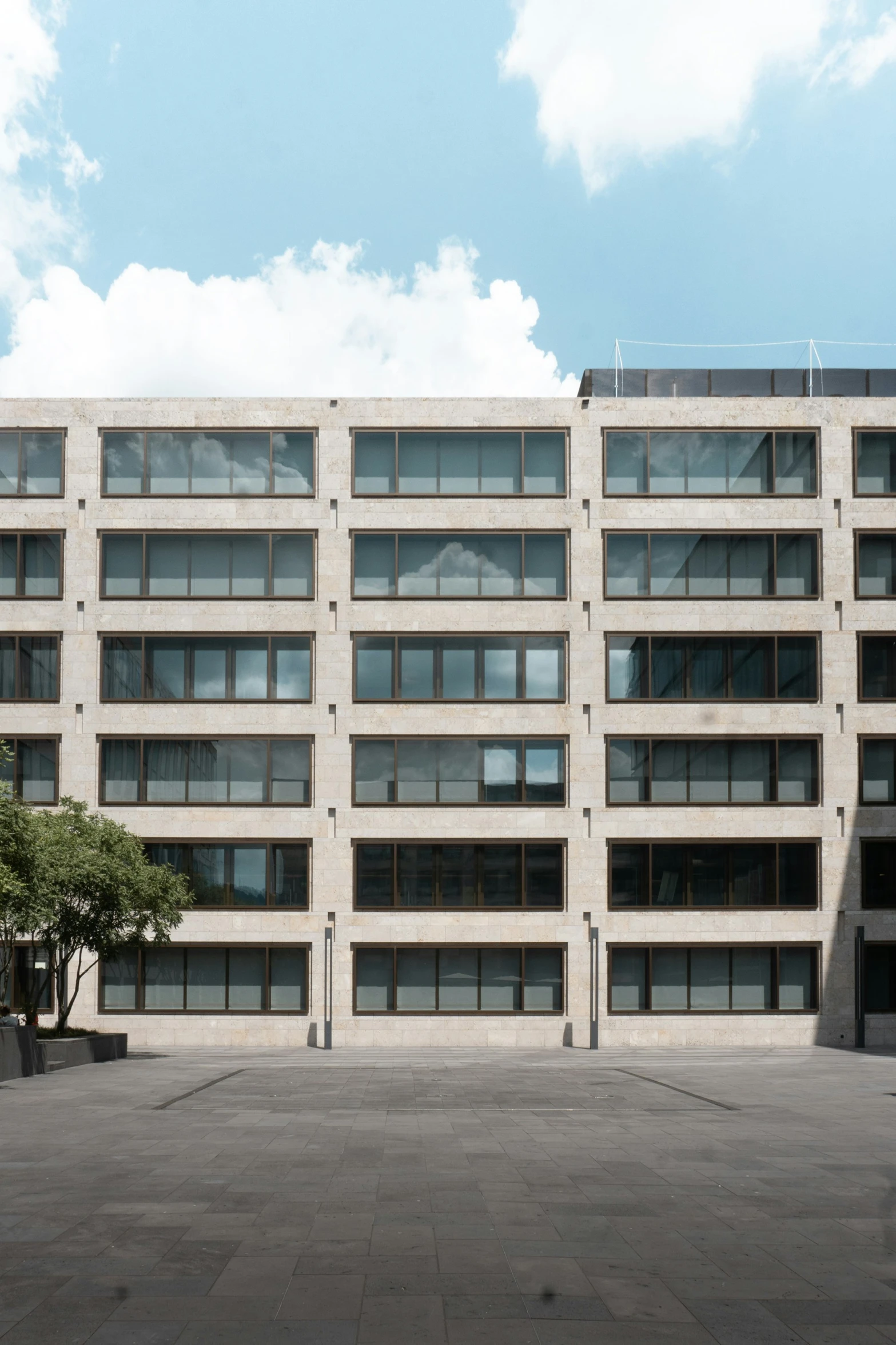 an outdoor courtyard has several large windows