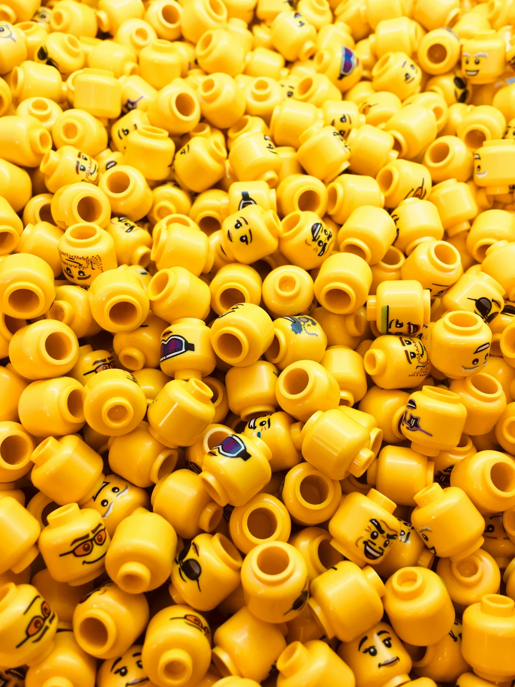 many yellow plastic vases in rows and sizes