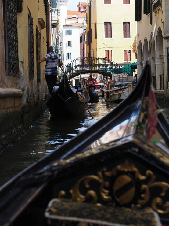 people riding in a gondola on a canal