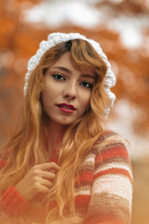 a close - up of a woman wearing a white crochet hat