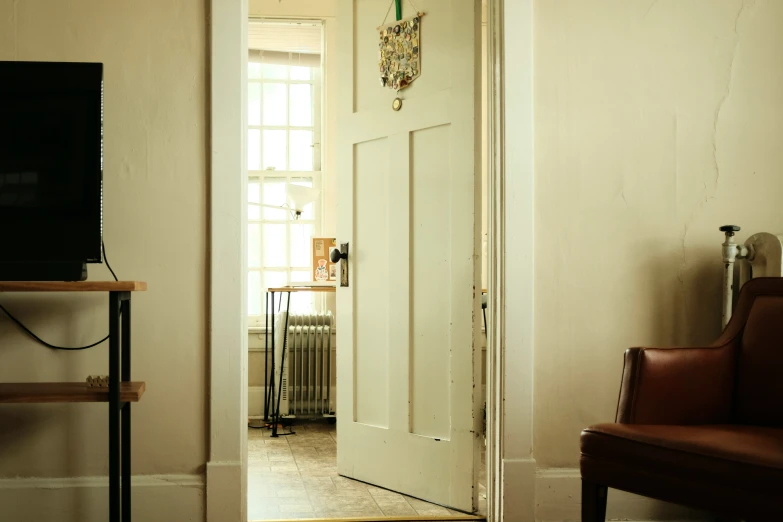 a room with white walls and doors opened