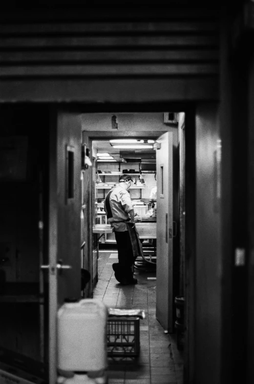 a man sitting on the edge of a chair in a kitchen